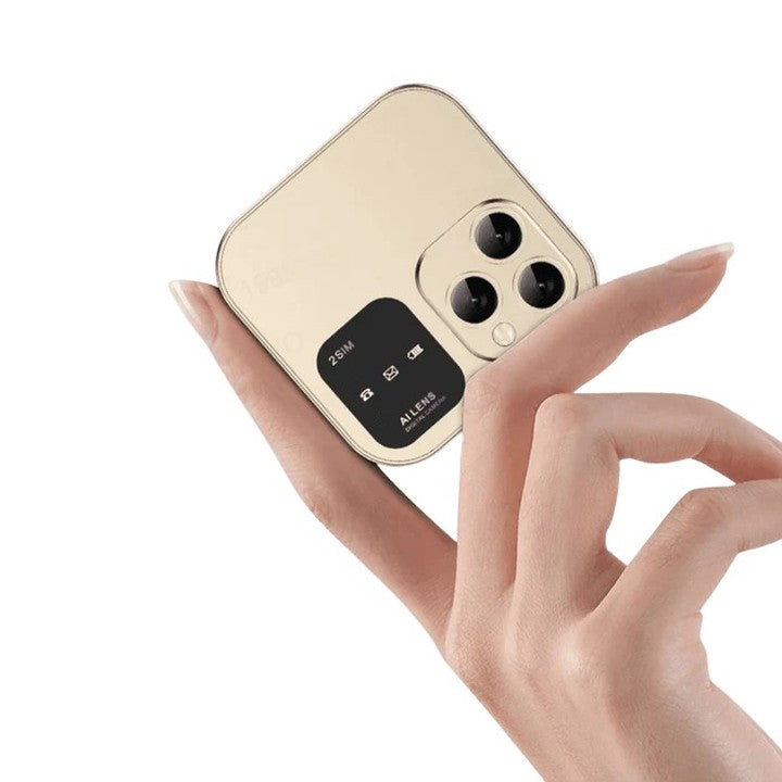 Gold Ipocket mini flip phone held between two fingers